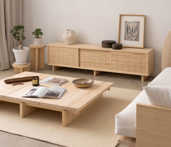 Minimalist living room with unvarnished natural wood furniture, including a coffee table, sideboard, and sofa — ideal for illustrating proper wood care and cleaning practices.